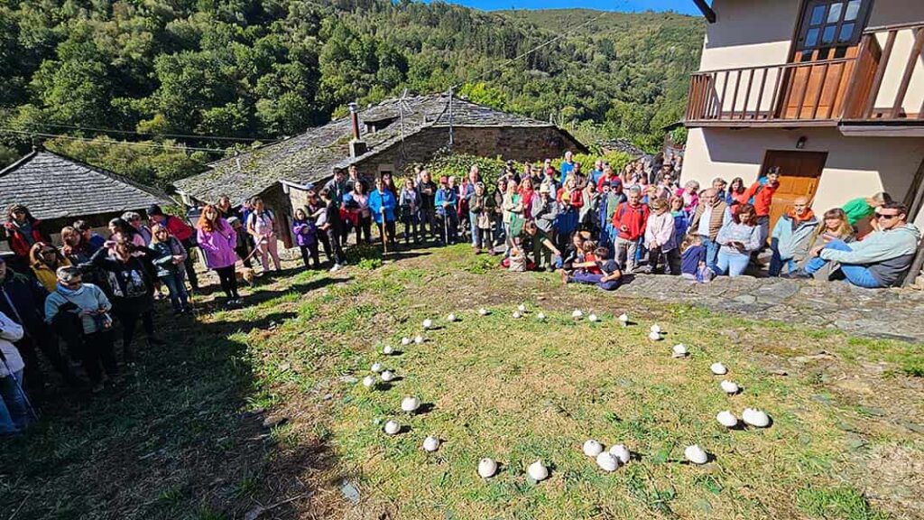 Público asistente junto al «Corro de bruxas» o «Corro de setas» de la artista Natalia Menéndez (Woodic), con motivo de la Festa de Arte en la Ruta con Arte (Santa Eulalia de Oscos).